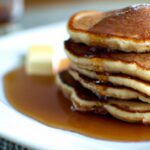 Fluffy Coconut Flour Pancakes Drizzled with Maple Syrup